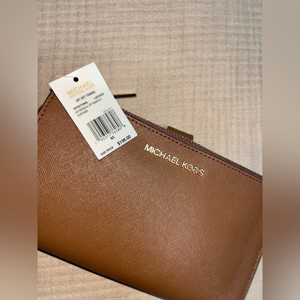 Michael Kors Brown Leather Women's wallet/clutch with wrist strap.